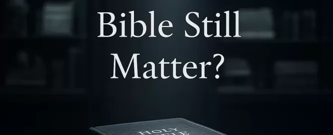 A bible sits on a table under a beam of light.